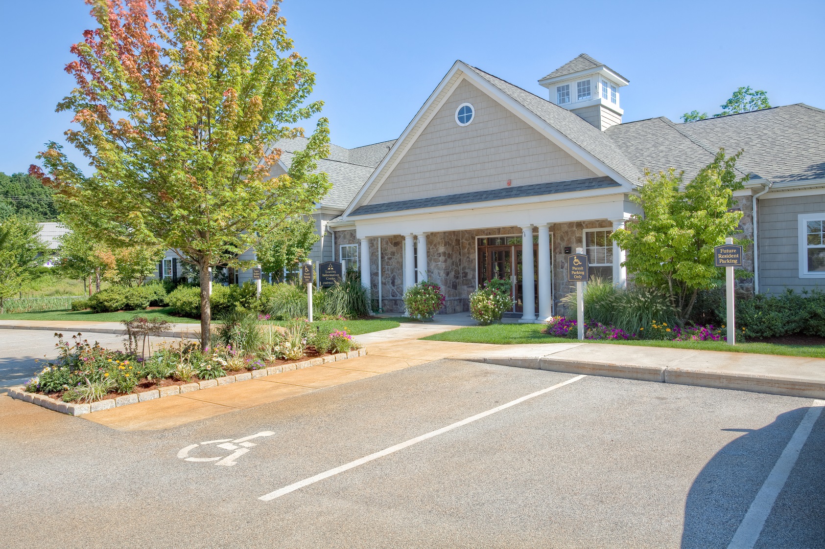 a parking lot in front of a house with a driveway