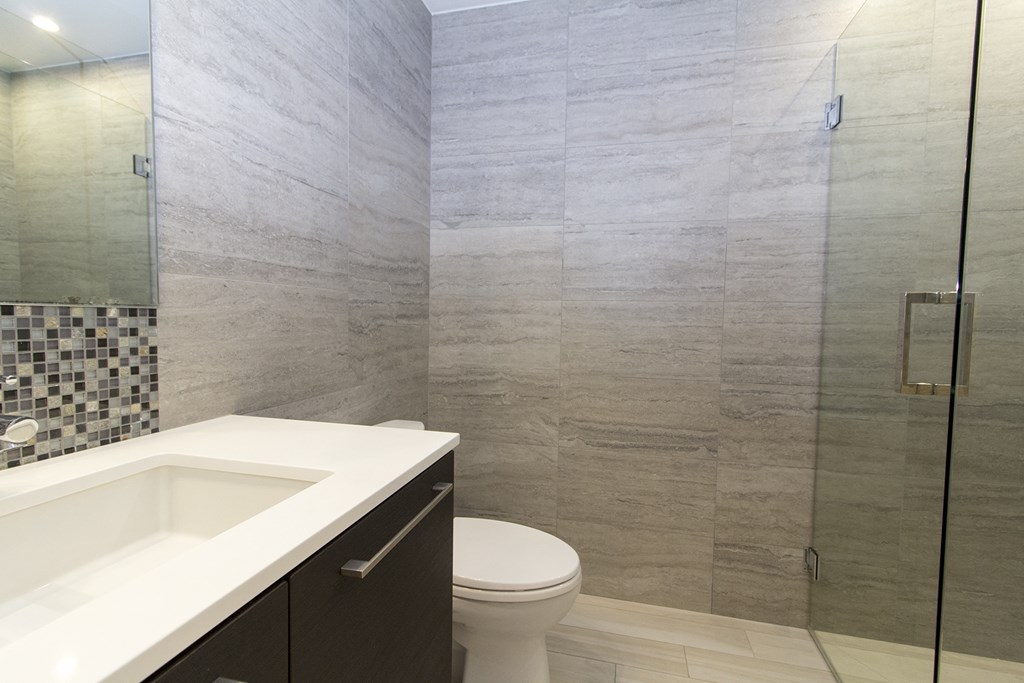 a bathroom with a toilet and a sink and a shower