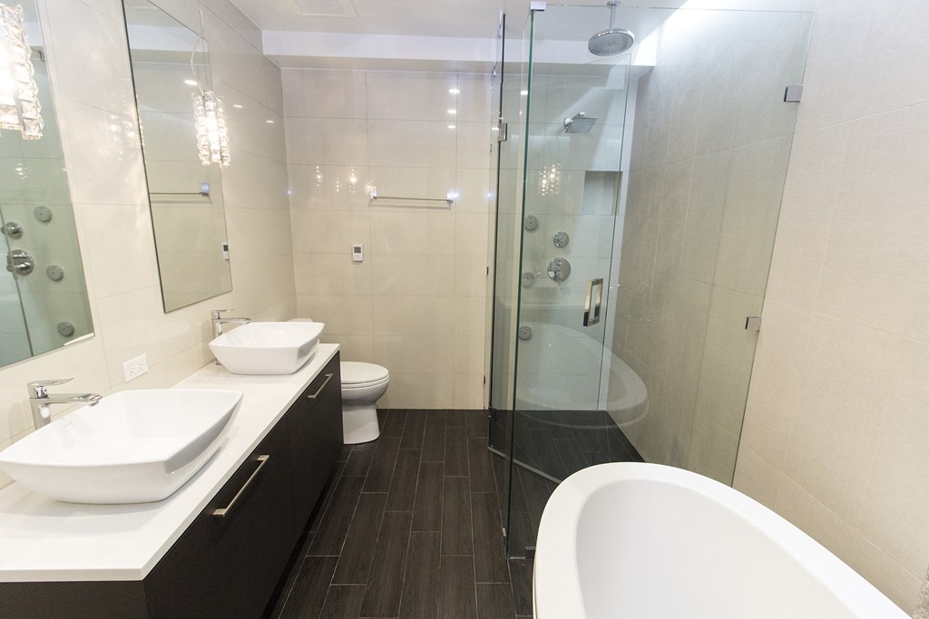 a bathroom with a tub and a sink and a shower