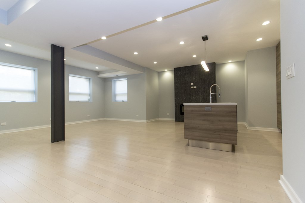 an empty living room with an island in the middle of it