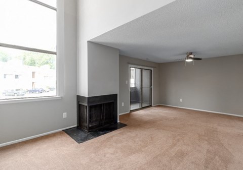 A room with a fireplace and a ceiling fan.