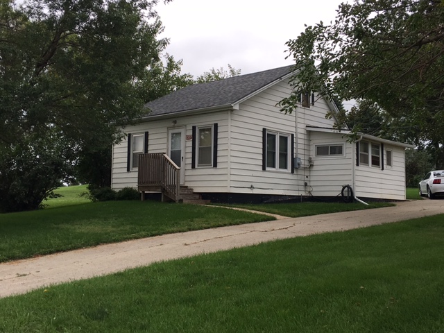 a white house with a yard and a sidewalk