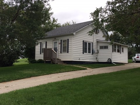 a white house with a yard and a sidewalk