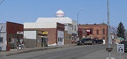 a city street with a building and a truck