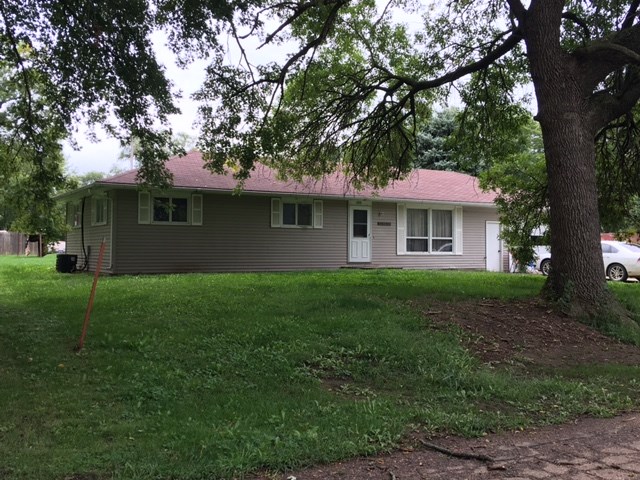 a remodeled house with a yard and trees