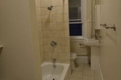 a white bathroom with a sink and a toilet