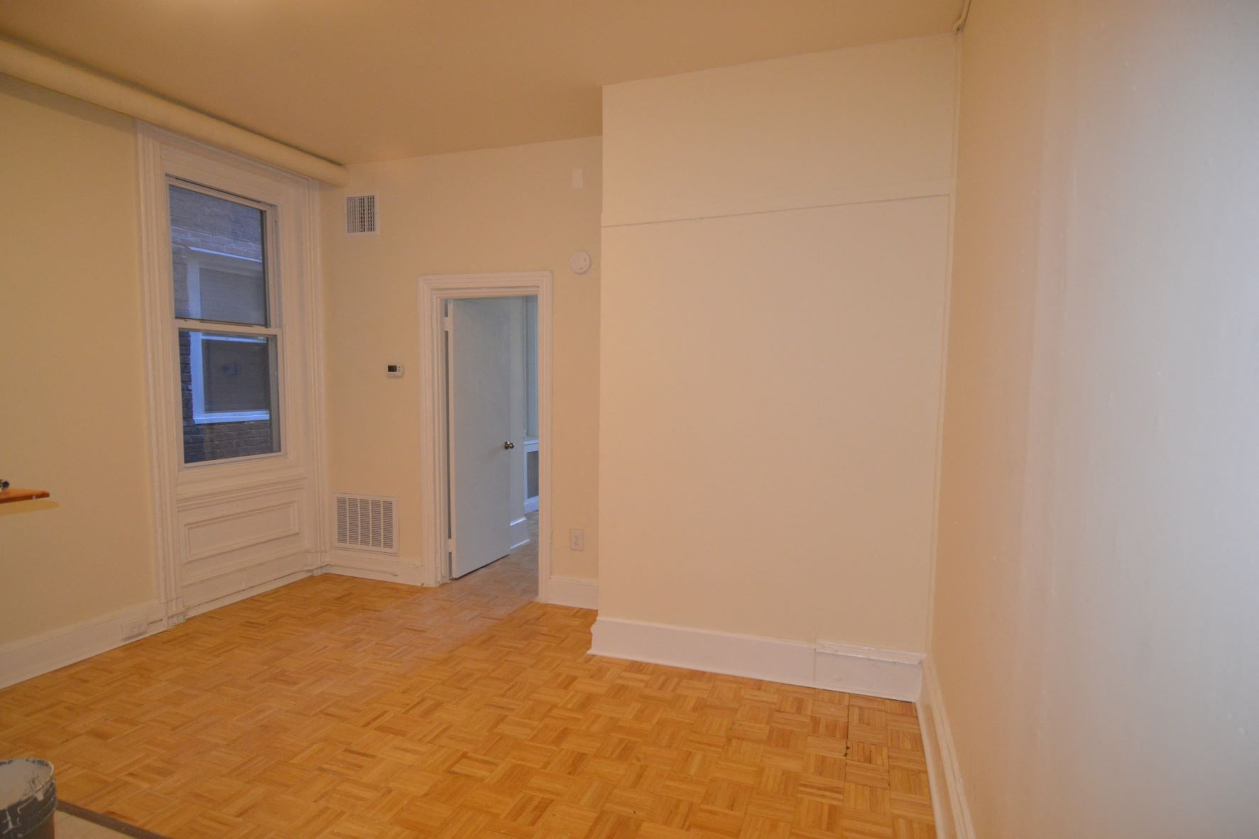 an empty room with a door and a window