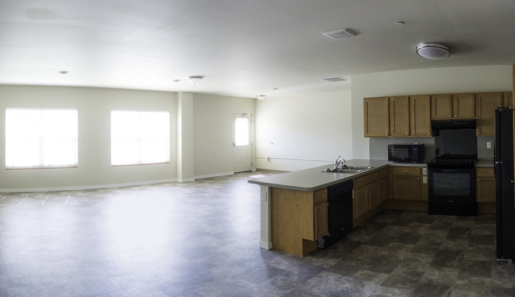 an empty kitchen and living room in a new home