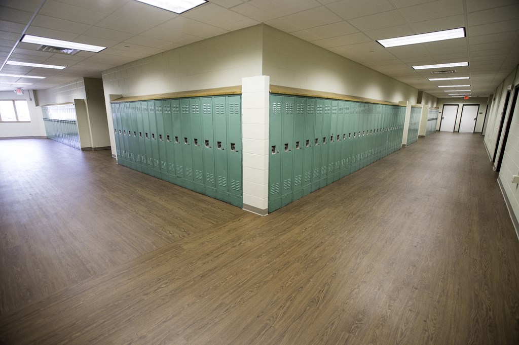 a row of lockers in a large room with wood floors