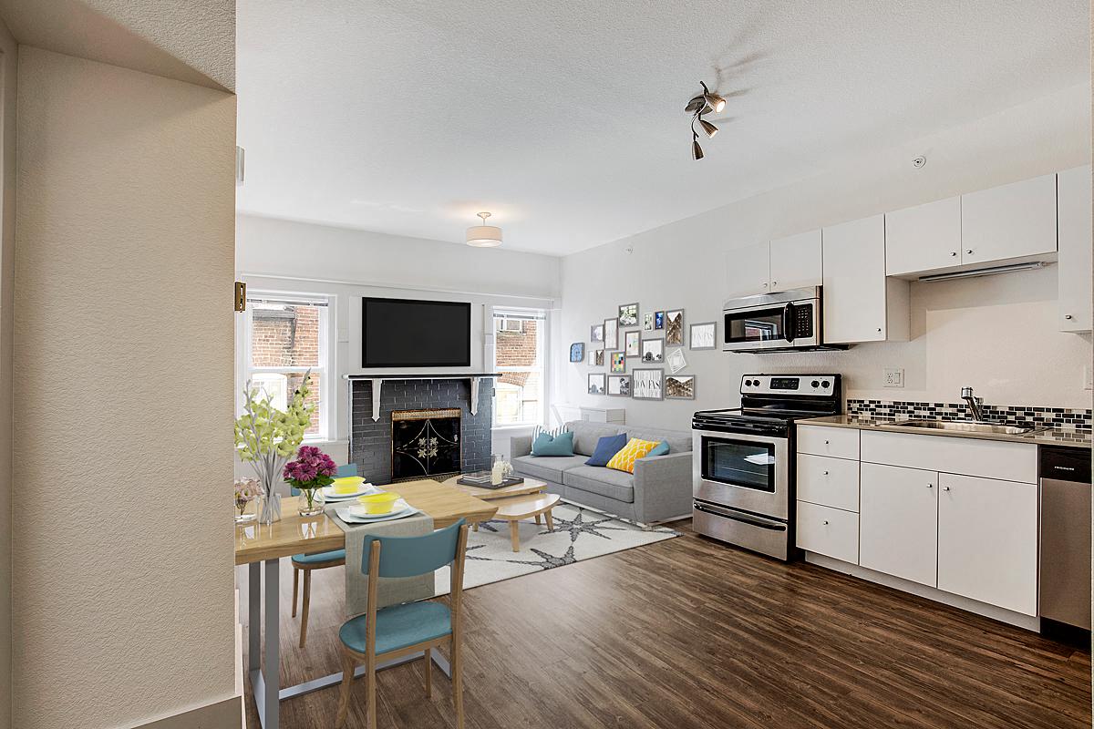 a kitchen and living room with a table and chairs