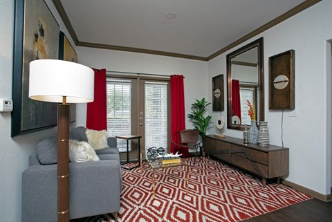 a living room with a red and white rug and a couch