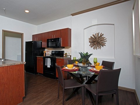 a kitchen and dining room with a table and chairs