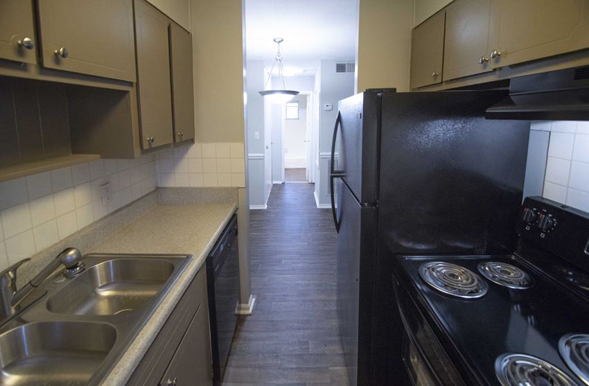 a kitchen with a sink and a refrigerator