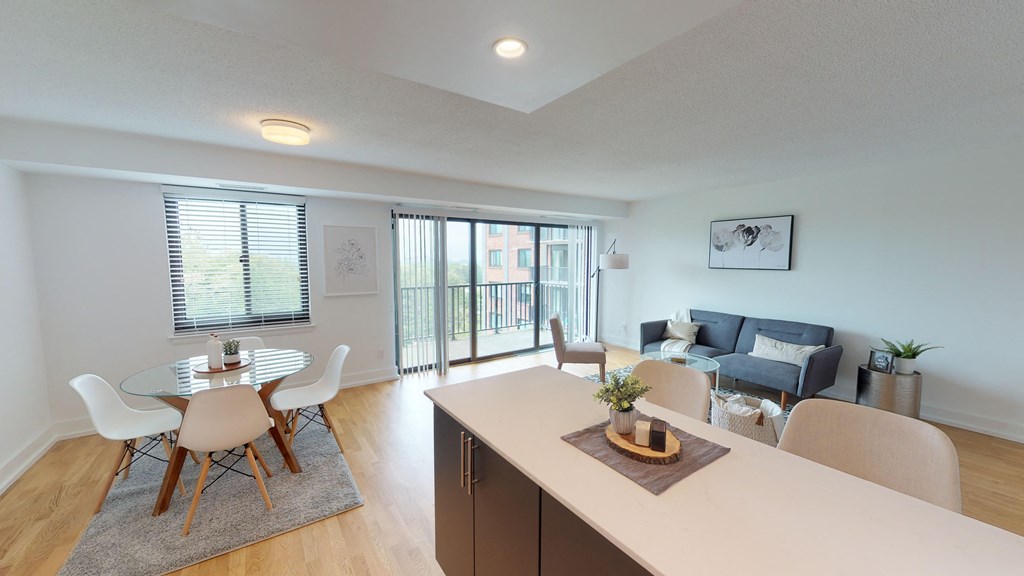 a living room and dining room with a table and chairs