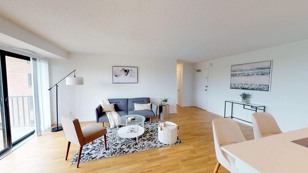 a living room with a couch and a table and chairs