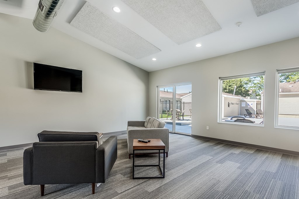 a living room with two couches and a coffee table and a tv