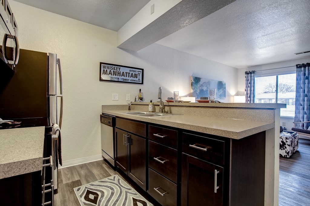 the kitchen has ample counter space and stainless steel appliances