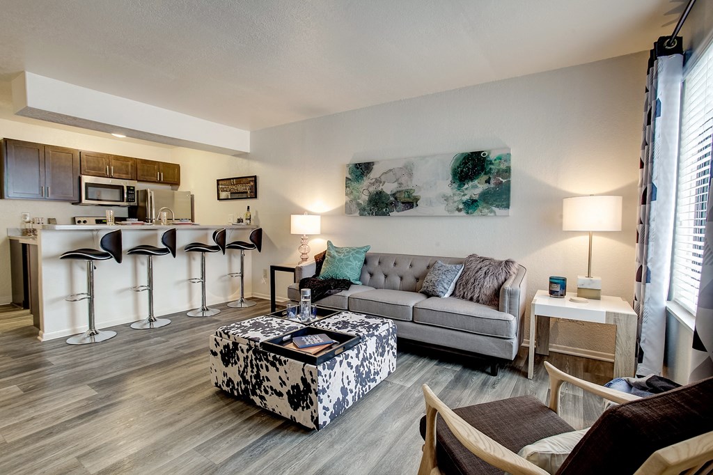 a living room and kitchen with a couch and a table