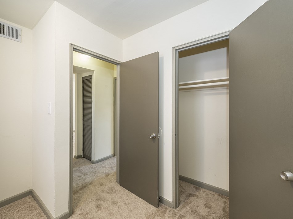 an empty room with three closet doors in it