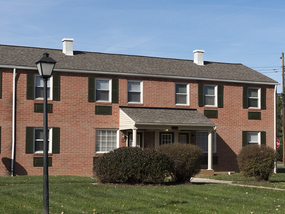 a brick house with a lamp post in front of it