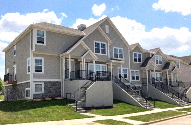 a row of houses with stairs and balconies