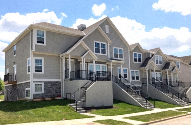 a row of houses with stairs and balconies