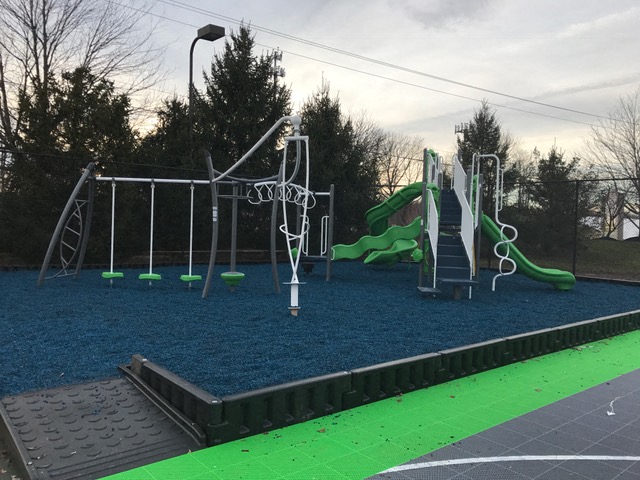 a playground with a slide and other playground equipment