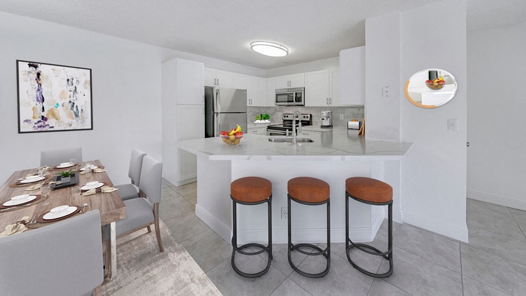 a kitchen with a breakfast bar and a table with stools