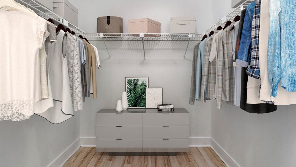 a closet with clothes hanging on a rack and a dresser