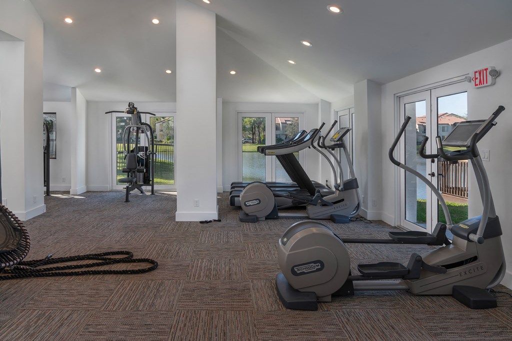 a gym with treadmills and other exercise equipment in a building