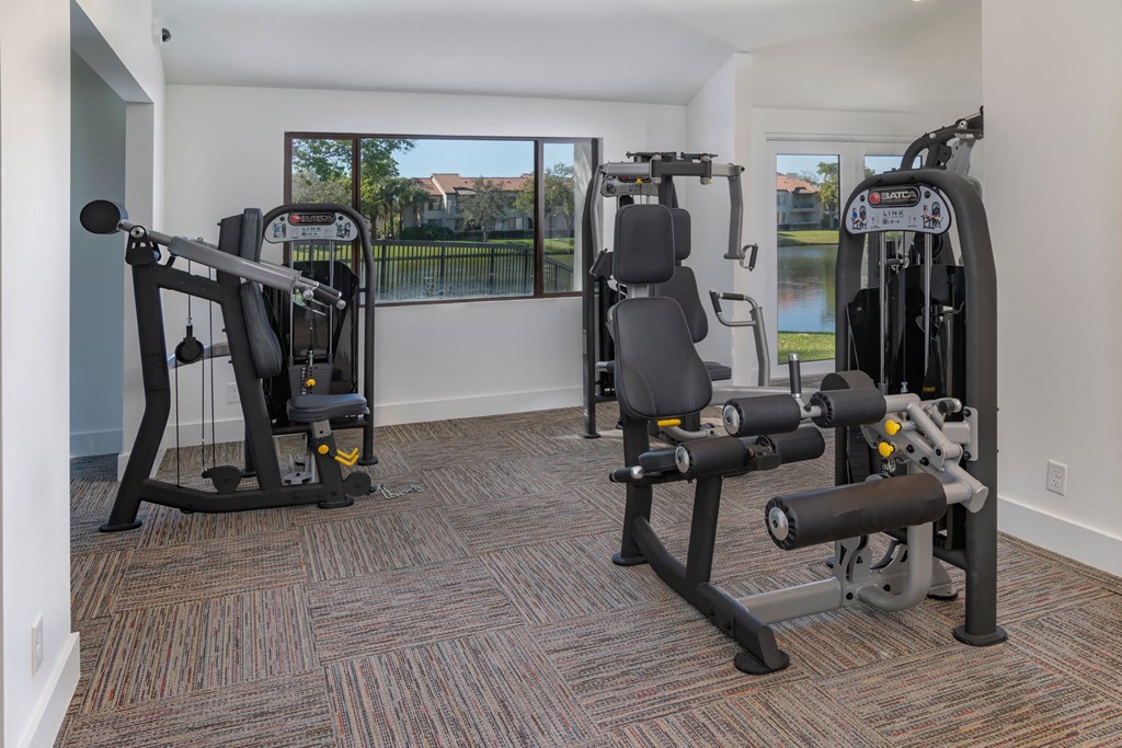 a gym with exercise equipment and a large window