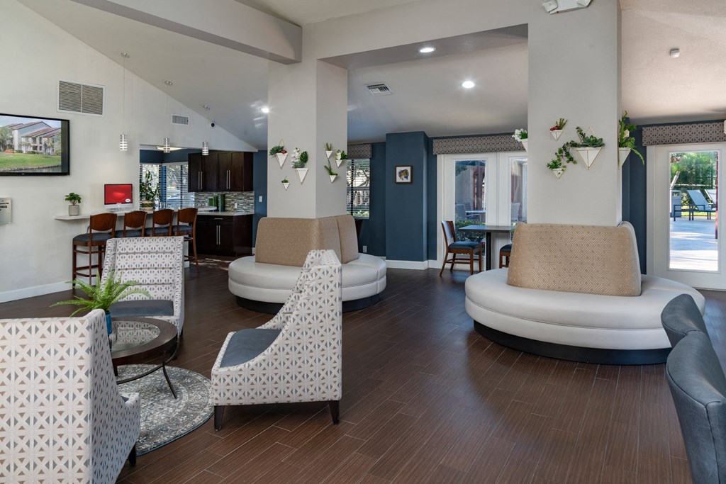 a living room with couches and chairs and a table with chairs