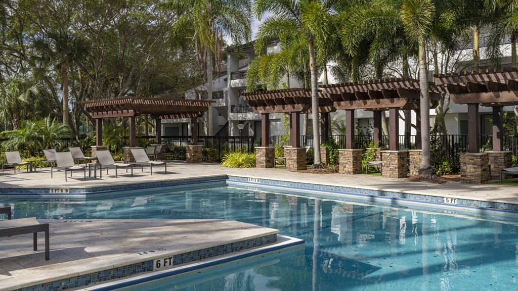 a swimming pool at a resort with palm trees