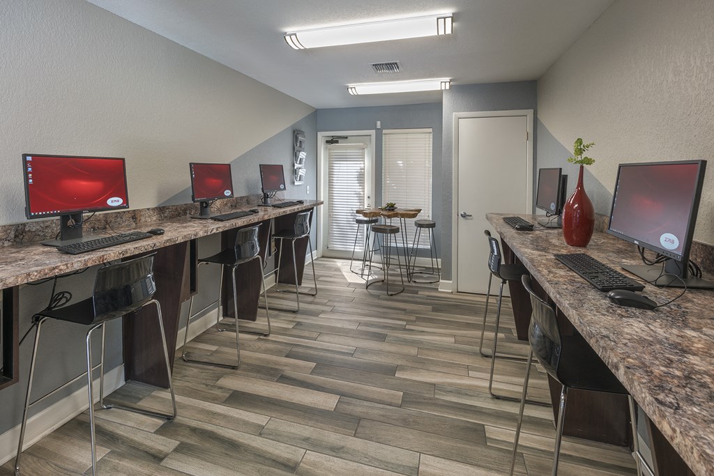 a computer room with computers on desks and chairs