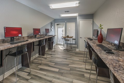 a computer room with computers on desks and chairs