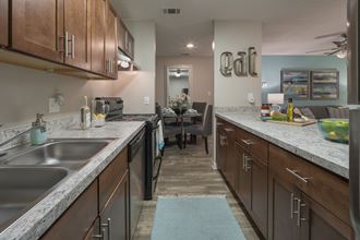 redesigned kitchen with granite countertops and stainless steel appliances at the reserve at south coast