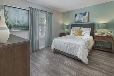 a bedroom with a bed and a dresser and a window