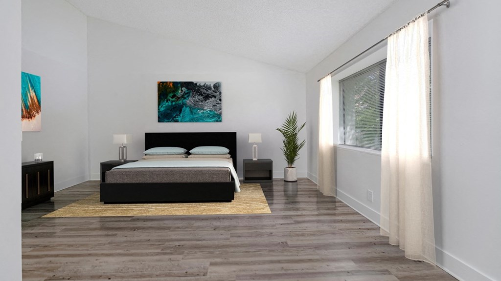 a bedroom with a bed and a large window