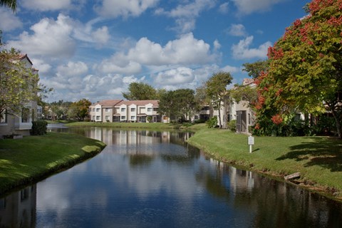 the view of a river with houses next to it