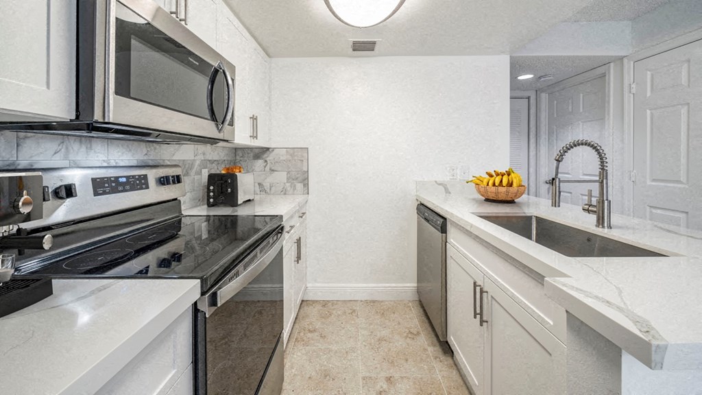 a kitchen with stainless steel appliances and white cabinets