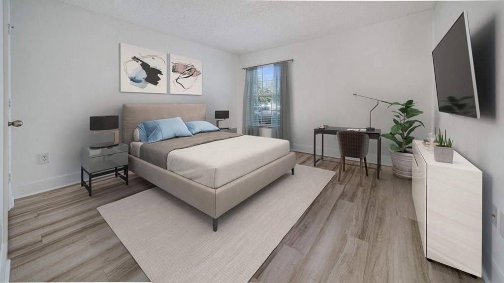 a bedroom with a bed and a desk and a window