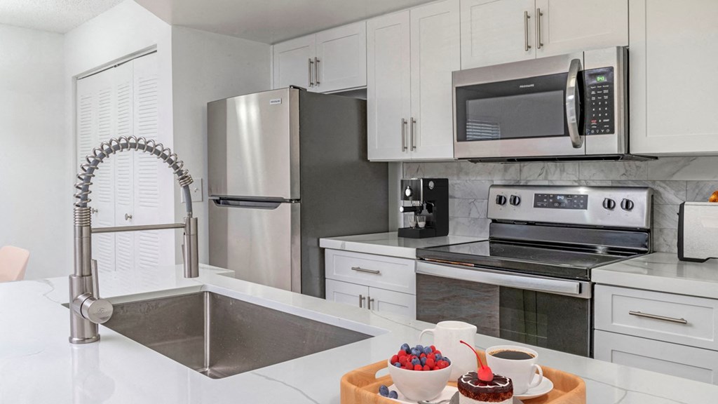 a kitchen with stainless steel appliances and a sink
