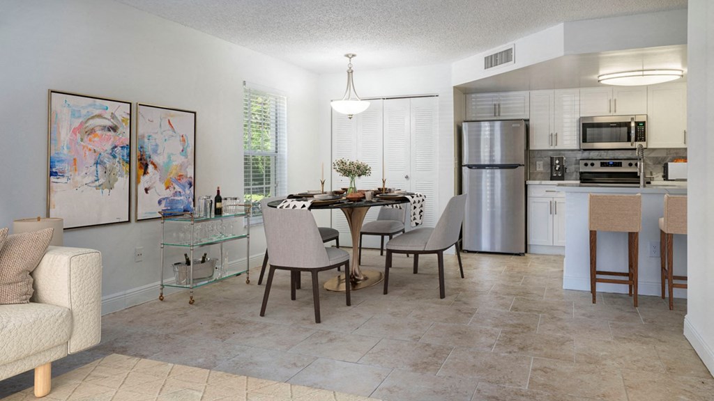 a kitchen and dining room with a table and chairs