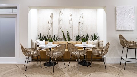 A dining room with a long table and chairs.