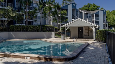 a swimming pool in front of an apartment building