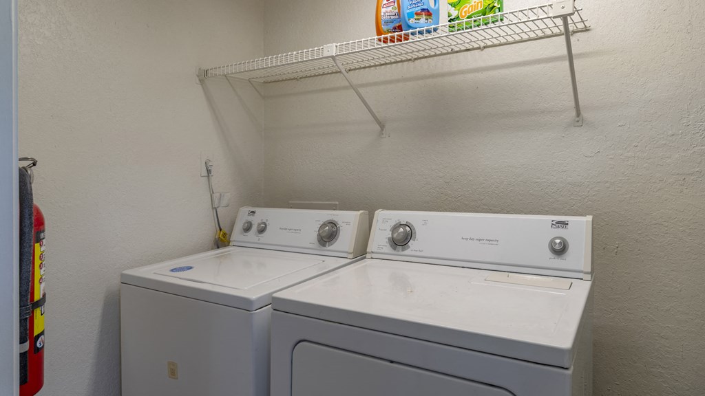 the laundry room is equipped with two washes and a dryer