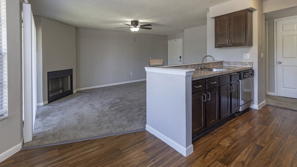 an empty kitchen and living room with a fireplace