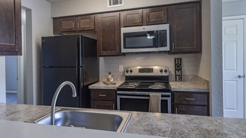 a kitchen with stainless steel appliances and wooden cabinets