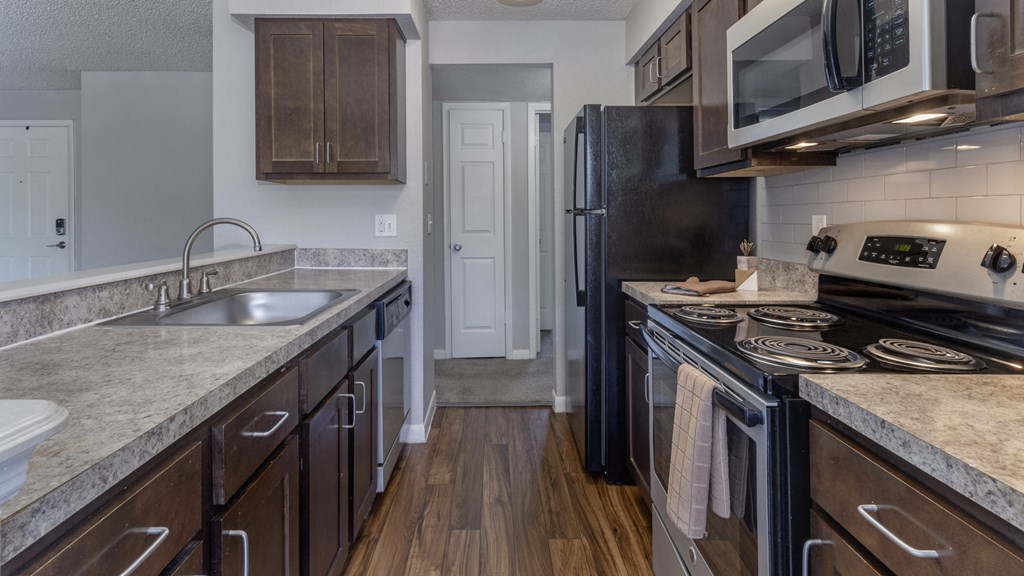a kitchen with granite counter tops and stainless steel appliances