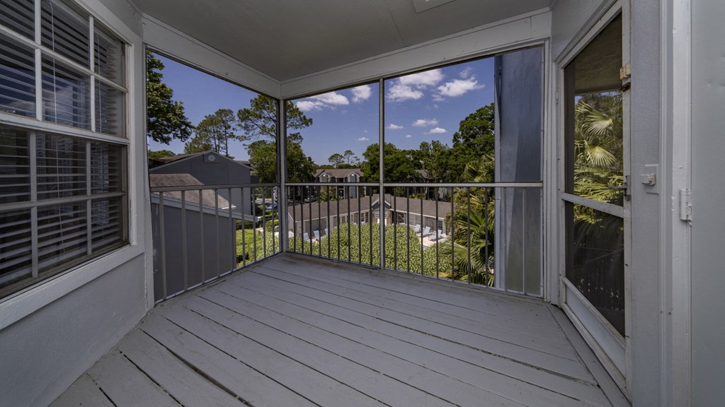 a balcony with a view of a yard and a house